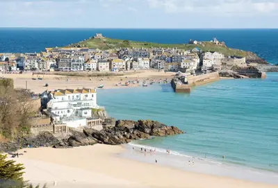 a group of people on a beach near the ocean at Lefransa in Carbis Bay, St Ives in Carbis Bay