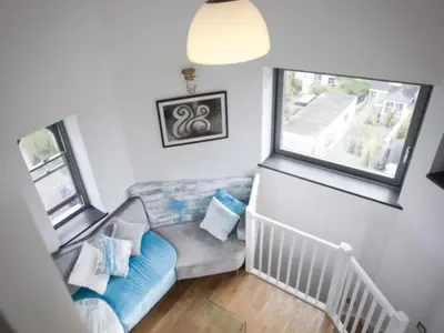 a living room with a couch and a window at The Observatory Tower in Falmouth