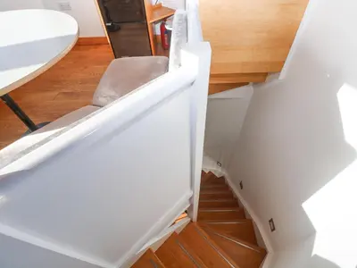 a stairwell with a chair next to a table at The Observatory Tower in Falmouth