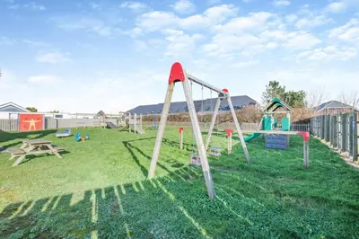 a playground with a slide in the grass at 2 Bed in St. Merryn oc-a30663 in St Merryn