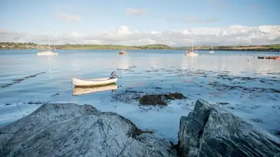a small boat in a large body of water with boats at 2 Bed in St. Merryn oc-a30663 in St Merryn