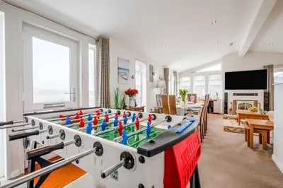 a living room with a foosball table in the middle at 2 Bed in St. Merryn oc-a30663 in St Merryn