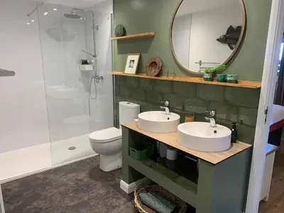 a bathroom with two sinks and a shower at Field End in Liskeard