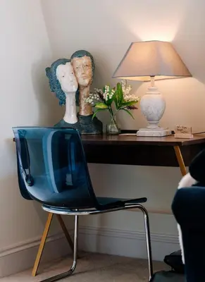 a blue chair in front of a desk with a lamp at Bijou Beachfront Gem, Rock in Padstow