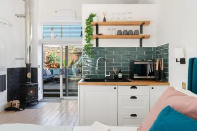 a kitchen with a sink and a stove at The Little Pines - 5 min walk to beach and sauna in Falmouth