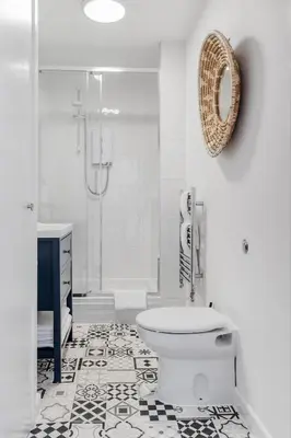 a white bathroom with a toilet and a shower at Harbour sea views in town centre - 3 Headland View in Falmouth