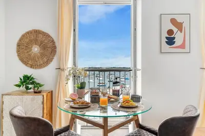 a dining room with a glass table and a window at Harbour sea views in town centre - 3 Headland View in Falmouth