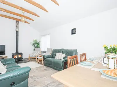 a living room with a couch and a table at The Dairy Barn in Camelford