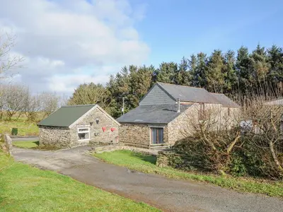 an old stone house on a dirt road at The Dairy Barn in Camelford