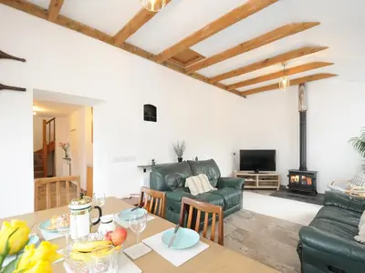 a living room with a table and a couch at The Dairy Barn in Camelford