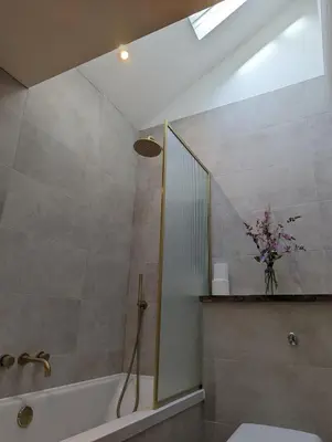 a bathroom with a shower and a toilet and a sink at Ramble & Rye - The Nest in Talland