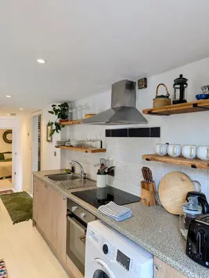 a kitchen with a sink and a stove at Ramble & Rye - The Nest in Talland
