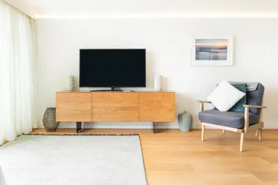 a living room with a television on a wooden dresser at 3 Bed in St. Eval oc-k30666 in Saint Eval