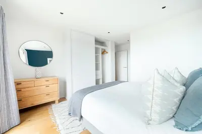 a bedroom with a bed with a mirror and a dresser at 3 Bed in St. Eval oc-k30666 in Saint Eval