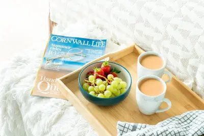 a tray with a bowl of fruit and two cups of coffee at 3 Bed in St. Eval oc-k30666 in Saint Eval