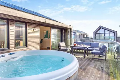 a hot tub on the deck of a house at 3 Bed in St. Eval oc-k30666 in Saint Eval