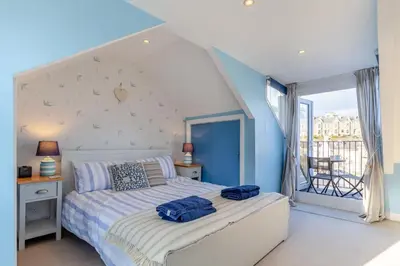 a bedroom with a bed with blue walls and a window at 3 Bed in St. Ives oc-c30654 in St Ives