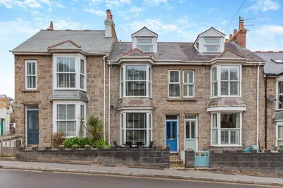 a large brick house with white windows at 3 Bed in St. Ives oc-c30654 in St Ives