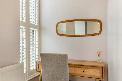a mirror hanging on a wall next to a table at 3 Bed in St. Ives oc-s30653 in St Ives