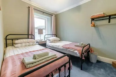 two beds in a room with a window at 3 Bed in St. Ives oc-s30653 in St Ives