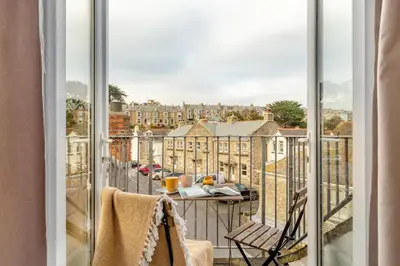 a balcony with a table and a view of a city at 3 Bed in St. Ives oc-s30653 in St Ives