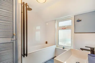 a white bathroom with a tub and a sink at 3 Bed in St. Ives oc-s30653 in St Ives