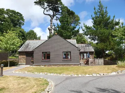 a gray house with a tree on top of it at 2br-sleeps4-pool-freeparking-trenythonestate in Par