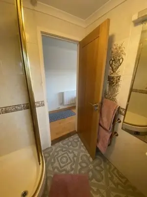 a bathroom with a door open to a room at Valley View in Port Isaac
