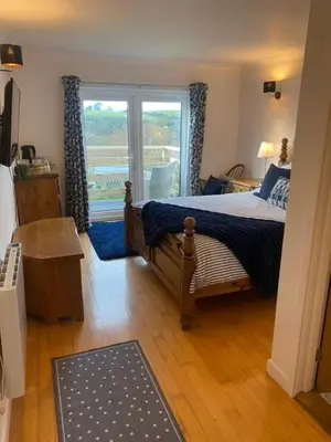 a bedroom with a bed and a window with a view at Valley View in Port Isaac