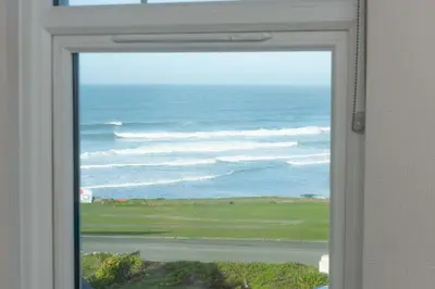 a view of the ocean through a window at Beachside Fistral, Newquay in Newquay