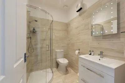 a bathroom with a shower and a toilet and a sink at Beachside Fistral, Newquay in Newquay