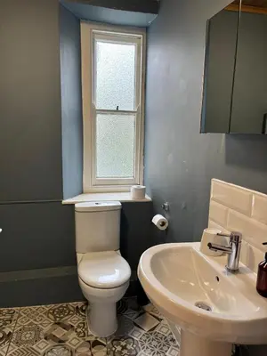 a bathroom with a white toilet and a sink at The Mariners in Falmouth