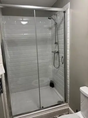 a shower with a glass door in a bathroom at The Mariners in Falmouth