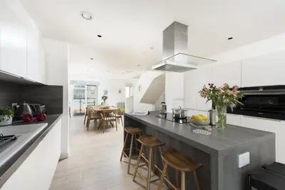 a kitchen with a large counter with stools in it at Close to the Beach, Wi-Fi, Parking in Newquay