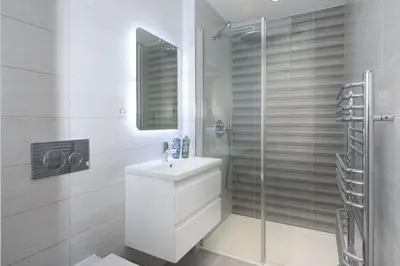 a white bathroom with a sink and a shower at Close to the Beach, Wi-Fi, Parking in Newquay