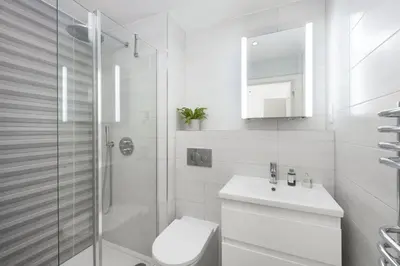 a white bathroom with a toilet and a sink at Close to the Beach, Wi-Fi, Parking in Newquay