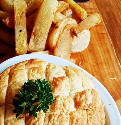 a plate of food with a pie and french fries at Jacobs Ladder Inn & Brewery in Falmouth