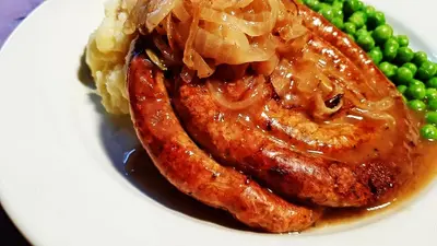 a plate of food with meat and mashed potatoes and peas at Jacobs Ladder Inn & Brewery in Falmouth