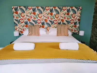 a bedroom with a large bed with two pillows at Jacobs Ladder Inn & Brewery in Falmouth