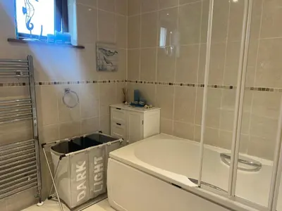 a bathroom with a tub and a glass shower at Double room with WiFi! in Saint Columb Major