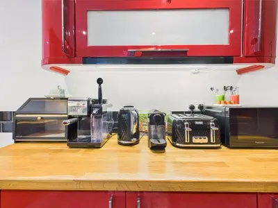 a kitchen counter with three microwaves on top of it at Cosy Cornish Cottage with Firepit & Parking in Newlyn East