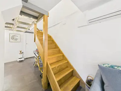a staircase in a room with white walls at Cosy Cornish Cottage with Firepit & Parking in Newlyn East