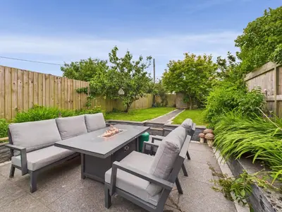 a patio with a table and two chairs at Cosy Cornish Cottage with Firepit & Parking in Newlyn East