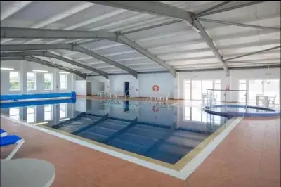 a large swimming pool with blue mats in it at Stunning Lodge with sea and country views, sleeps 6 in Newquay
