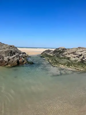 a body of water between two large rocks at Stunning Lodge with sea and country views, sleeps 6 in Newquay