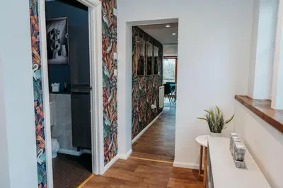 a hallway with a door leading into a room at Heron's Perch- A pond-side retreat with cinema room in Callington