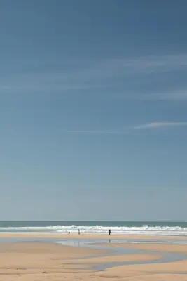 a view of the beach with the ocean in the background at Bright & Modern Townhouse Private Parking in Newquay