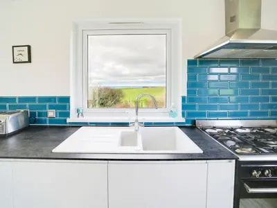 a kitchen with a sink and a window at Port View House in Bodmin