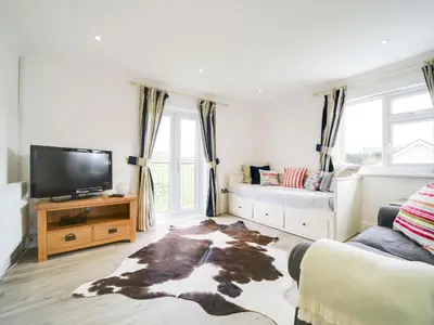 a living room with a tv and a couch at Port View House in Bodmin