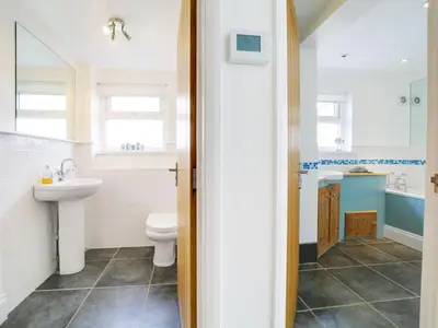 a bathroom with a toilet and a sink at Port View House in Bodmin